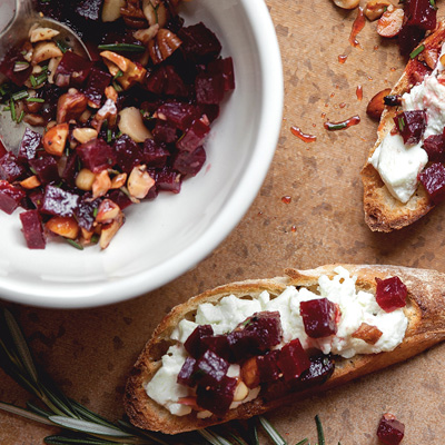 Warm Goat Cheese Crostini with Beet, Nut and Rosemary Topping
