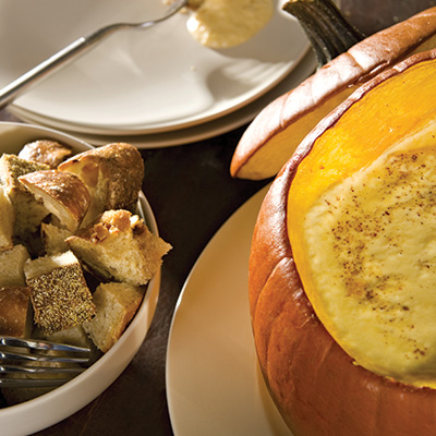 Artichoke and fall fruit fondue in a pumpkin