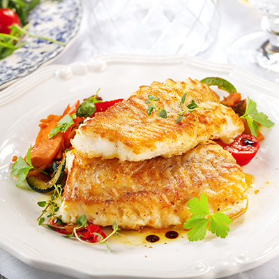 Pan-fried Pollock with mustard crust accompanied by potatoes and red peppers saudéed in thyme