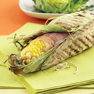 Grilled corn on the cob with prosciutto and herb butter