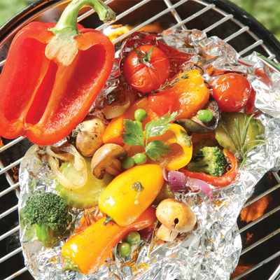Wrapped fresh vegetables on the barbecue