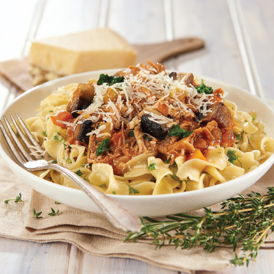 Pork stew with spinach and Portobello mushrooms served with garlic egg noodles